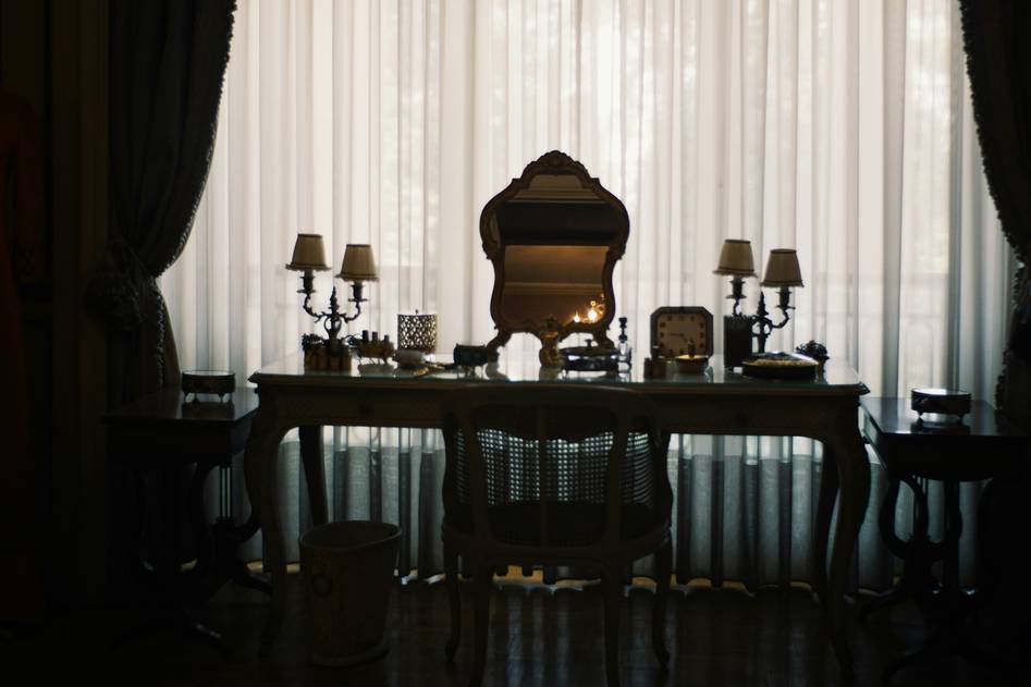 Close-up of a sleek makeup stand holding brushes and cosmetics