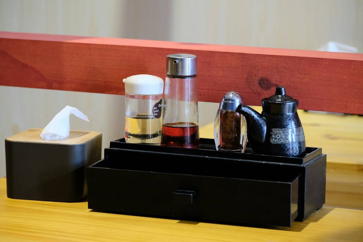 Side-by-side comparison: chaotic makeup pile vs. tidy acrylic makeup organizer stand with labeled compartments