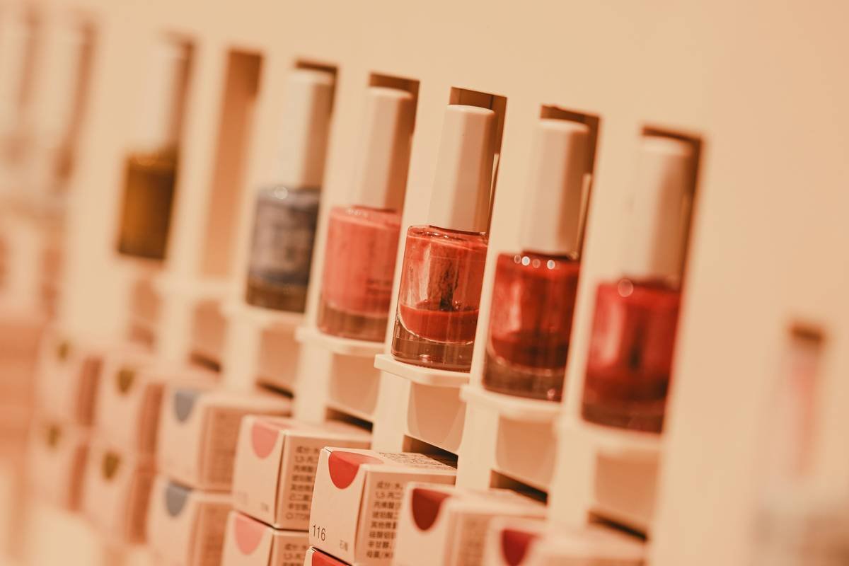 Side-by-side image: left shows a cluttered vanity with spilled makeup; right shows the same space organized with a clear acrylic makeup stand rack holding brushes, foundations, and palettes vertically