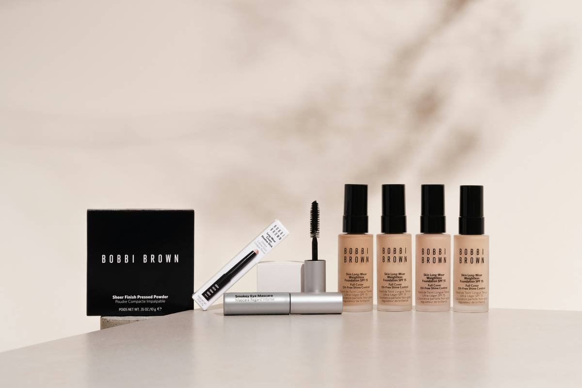 Minimalist makeup organization system with tiered acrylic stand holding daily essentials